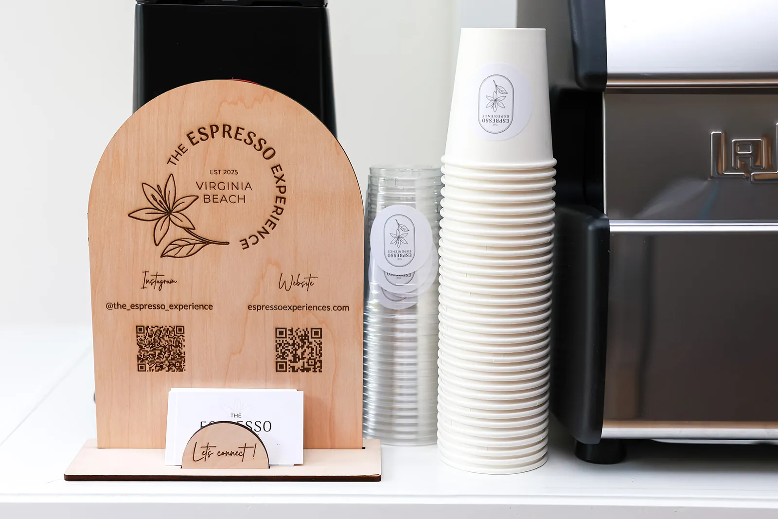 Close-up of the wooden branded sign and cups on the espresso cart