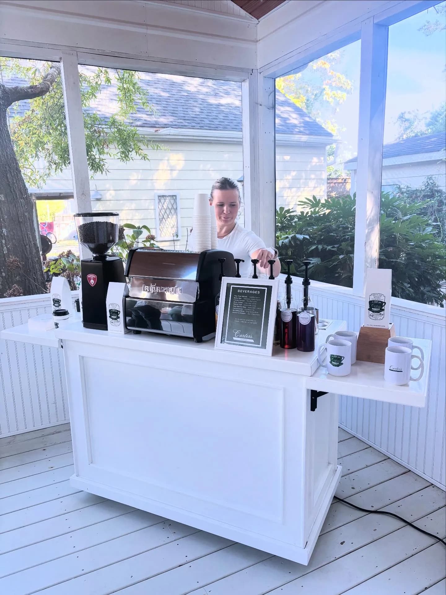 White espresso cart set up on a screened porch for a private celebration