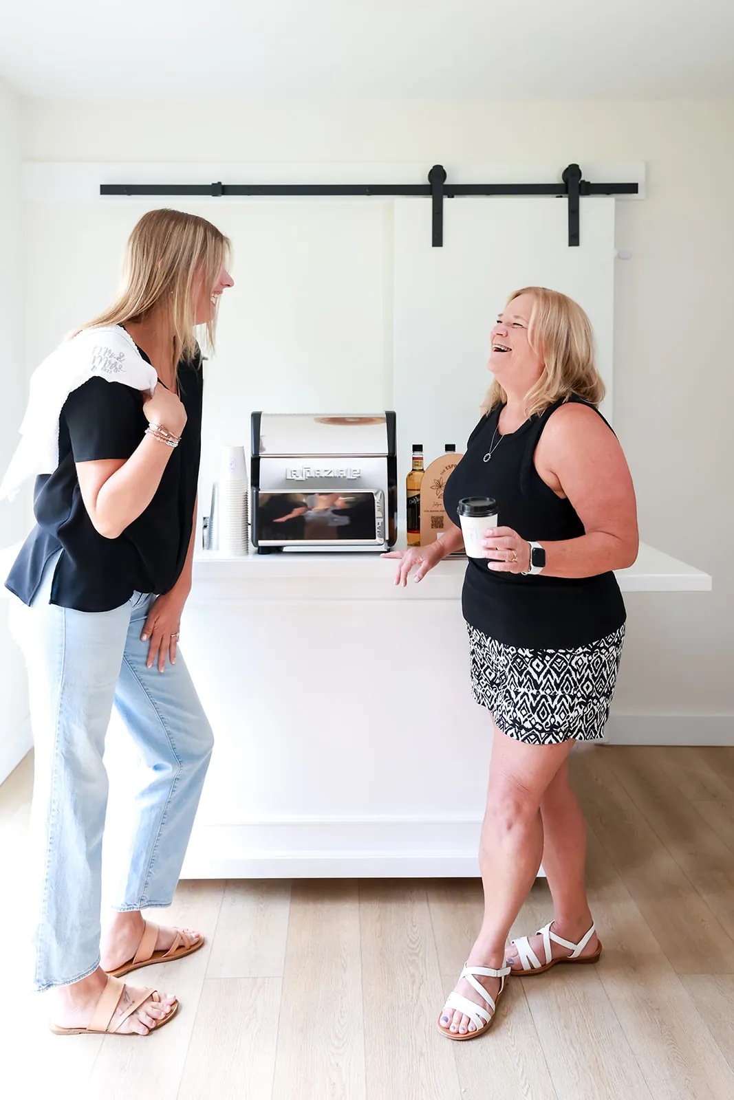 Guests chatting with drinks in hand beside the espresso cart